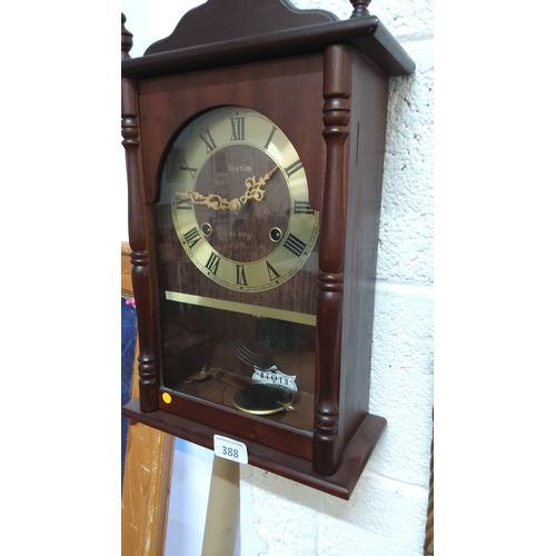 388 - Acctim wooden-cased pendulum wall clock, arched brass-tone Roman numeral dial, turned side columns a... 