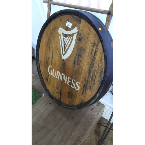 390 - Guinness branded wooden barrel head, circular oak panel with stencilled harp emblem and lettering, b... 