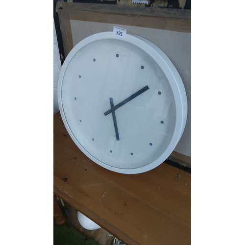 391 - Circular white wall clock with dot hour markers and black bar hands, contemporary minimalist design.... 