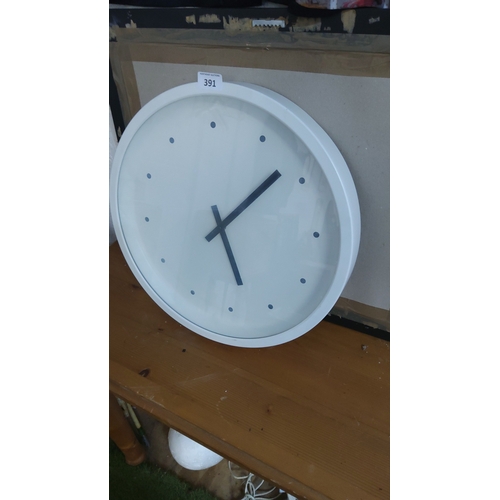391 - Circular white wall clock with dot hour markers and black bar hands, contemporary minimalist design.... 