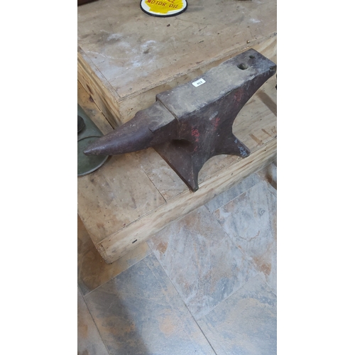 403 - Cast iron blacksmith’s anvil with tapered horn, hardy and pritchel holes, on splayed foot base.