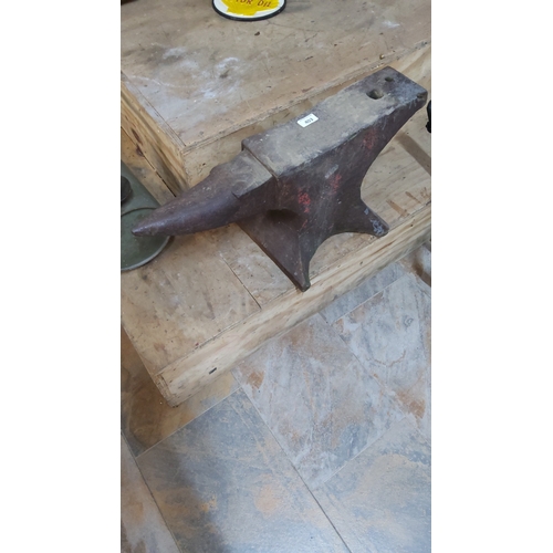 403 - Cast iron blacksmith’s anvil with tapered horn, hardy and pritchel holes, on splayed foot base.