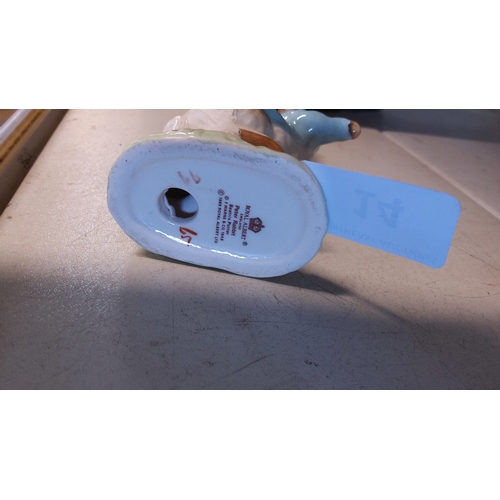 14 - A Royal Albert porcelain figure of Peter Rabbit, modelled standing and dressed in a blue jacket, on ... 