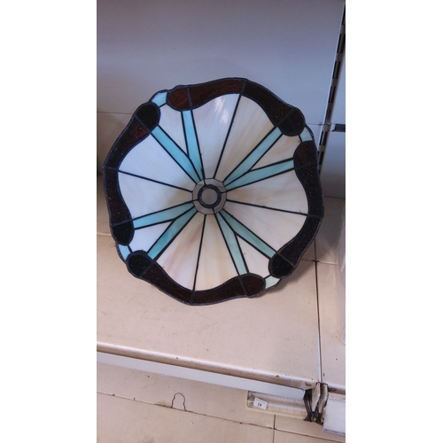 18 - A leaded stained-glass lampshade, of tapered polygonal form, the panels in opalescent cream with pal... 