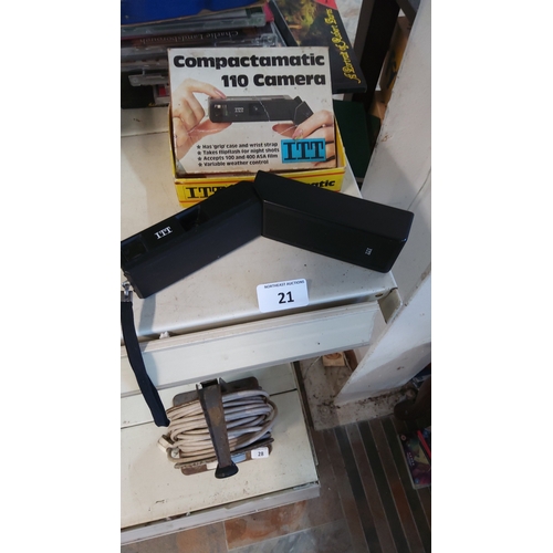 21 - An ITT Compactamatic 110 cartridge film camera, black plastic body with wrist strap, presented with ... 