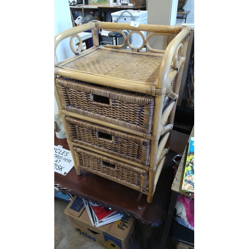 24 - A rattan and wicker three-drawer bedside chest, with bamboo-effect frame, woven top and side panels,... 
