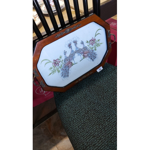 32 - A rectangular wooden serving tray with cut corners, fitted with brass-tone handles and mounts, the c... 