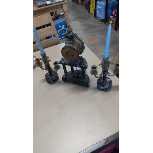 44 - Three-piece French mantel garniture comprising a drum-head clock with white enamel dial, on a black ... 