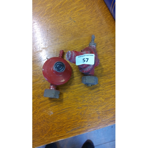 57 - Pair of red-painted propane gas regulators with hose barbs and threaded connectors, one marked with ... 