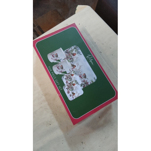 26 - Five-piece gift set comprising two ceramic mugs, two coasters and a rectangular tray, decorated with... 