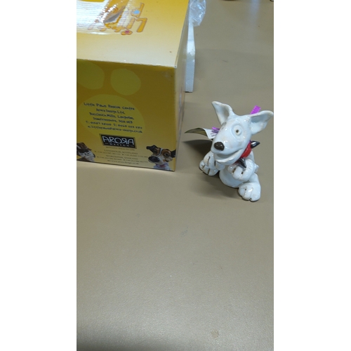 29 - A Little Paws white ceramic dog figurine, modelled as a playful terrier with red bandana and purple ... 