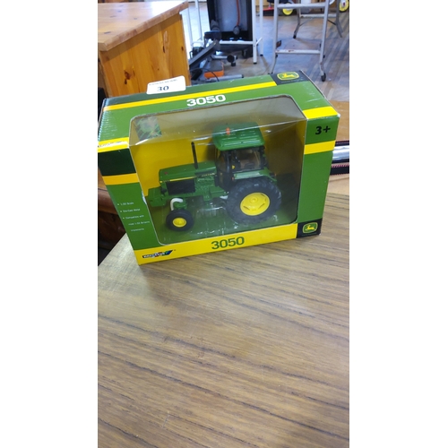 30 - A boxed John Deere 3050 tractor model by Britains, 1:32 scale die-cast metal, in green and yellow li... 