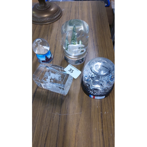 35 - Group of 3 decorative snow globes, comprising a polar bear and ice-form scene, an Eiffel Tower souve... 