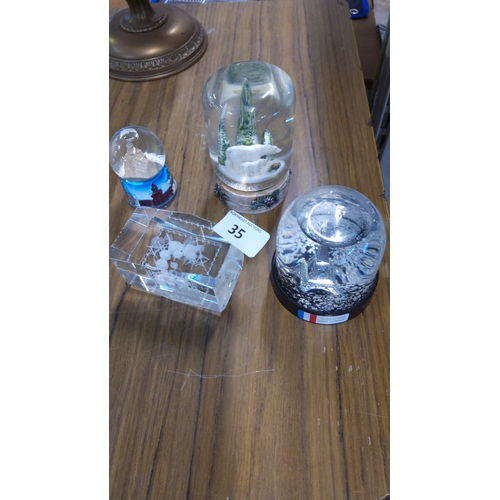35 - Group of 3 decorative snow globes, comprising a polar bear and ice-form scene, an Eiffel Tower souve... 