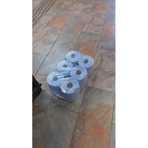 47 - Set of 6 blue paper towel rolls, shrink-wrapped as a multipack, each roll with cardboard core.