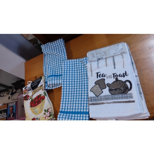 19 - Group of assorted kitchen textiles, including a packaged set of three “Tea and Toast” tea towels, tw... 