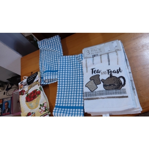 19 - Group of assorted kitchen textiles, including a packaged set of three “Tea and Toast” tea towels, tw... 