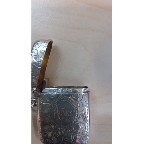 102 - Silver vesta case of rectangular form, the hinged cover and body engraved overall with foliate scrol... 