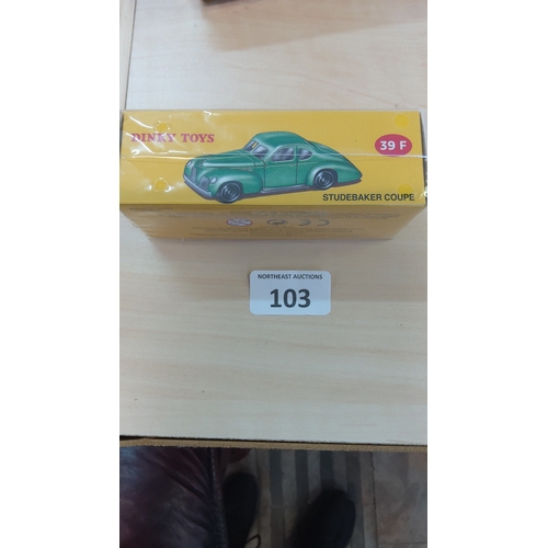 103 - Dinky Toys Studebaker Coupé, model 39F, in the original yellow illustrated box depicting a green sal... 