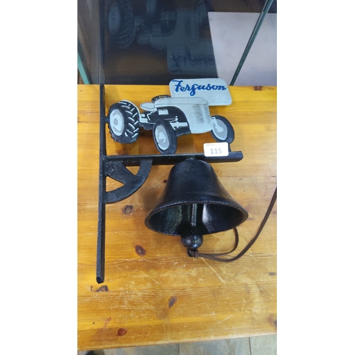115 - Cast iron wall-mounted bell, the bracket surmounted by a painted silhouette of a Ferguson tractor wi... 
