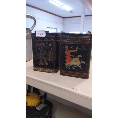 129 - Two chinoiserie-decorated tinplate tea caddies, each of rectangular section with fitted cover.