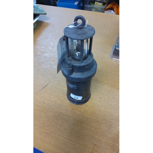 13 - Rare battery operated miners lantern in blackened metal, the cylindrical body fitted with a domed gl... 