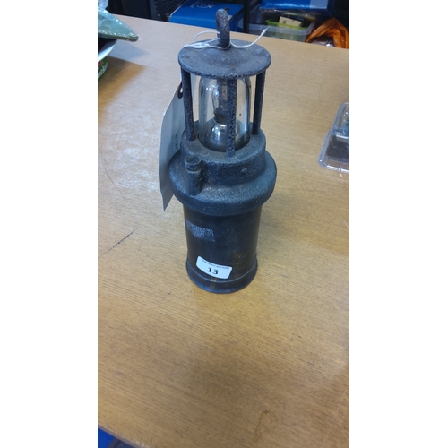 13 - Rare battery operated miners lantern in blackened metal, the cylindrical body fitted with a domed gl... 