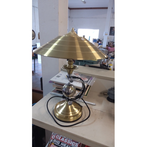 132 - Mid-century Modern  table lamp with stepped conical shade, chromed spherical reservoir, and black ar... 