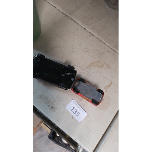 135 - A pair of die-cast model cars, comprising a maroon Mini saloon and a red Mini estate ‘23’. The latte... 