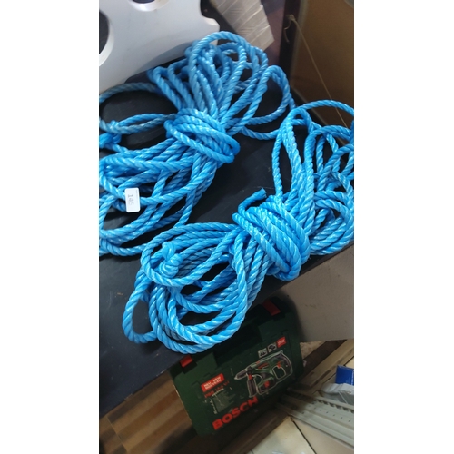 145 - A group of bright blue synthetic rope coils, three-strand twisted construction, suitable for marine ... 