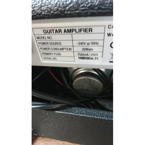 154 - Solid-state guitar amplifier in black tolex, with carry handle and front grille; control panel with ... 