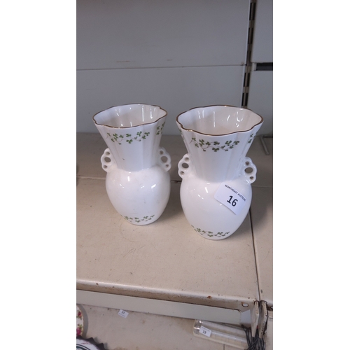 16 - A pair of Royal Tara porcelain vases, of ovoid form with waisted necks and pierced side lugs, gilt-e... 