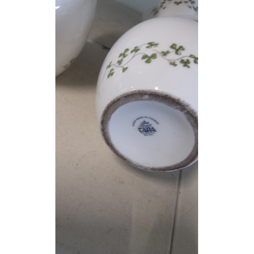 16 - A pair of Royal Tara porcelain vases, of ovoid form with waisted necks and pierced side lugs, gilt-e... 