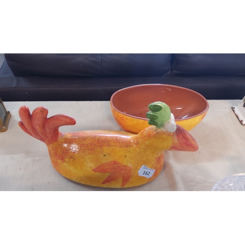 162 - Glazed ceramic lidded tureen modelled as a stylised bird, the mottled ochre body with red tail and w... 