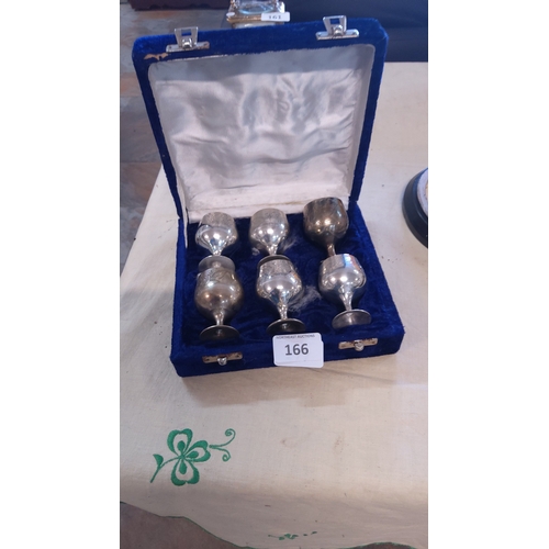166 - A fitted case containing six silver-plated liqueur goblets, each of rounded bowl form on a knopped s... 