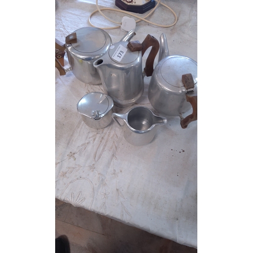 173 - A group of mid-20th century aluminium tea wares comprising three lidded teapots with brown handles a... 