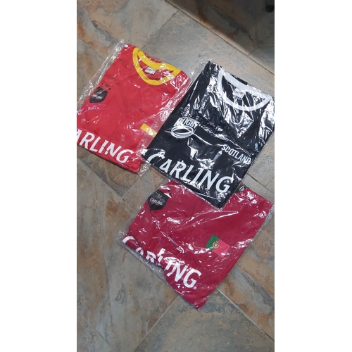 24 - A group of Carling-branded shirts (Portugal & Spain soccer + Scotland Rugby all size large)