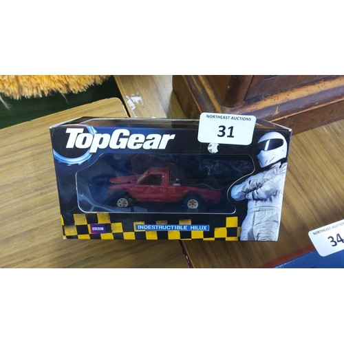 31 - BBC Top Gear boxed die-cast model ‘Indestructible Hilux’—a red Toyota Hilux pickup within a window d... 
