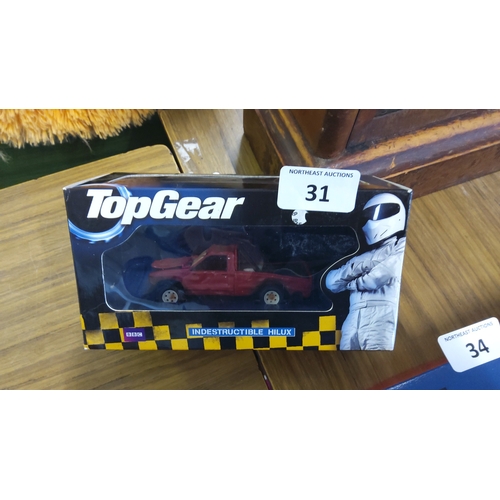 31 - BBC Top Gear boxed die-cast model ‘Indestructible Hilux’—a red Toyota Hilux pickup within a window d... 