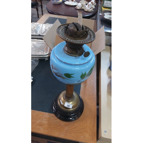 38 - A Victorian-style oil lamp with brass burner and chimney gallery, the blue opaline glass font enamel... 