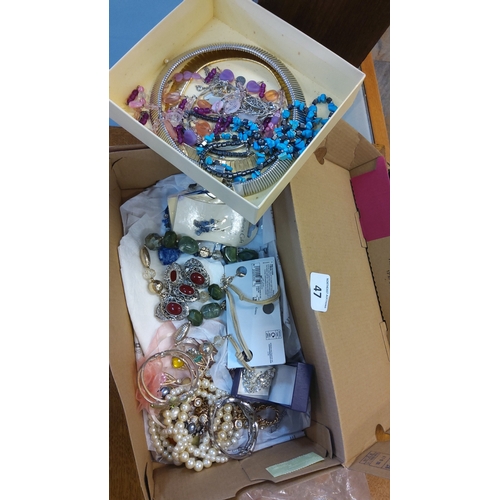47 - A group of costume jewellery including bead necklaces, charm and link chains, bangles, faux-pearl st... 