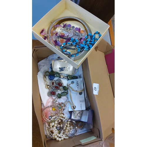 47 - A group of costume jewellery including bead necklaces, charm and link chains, bangles, faux-pearl st... 