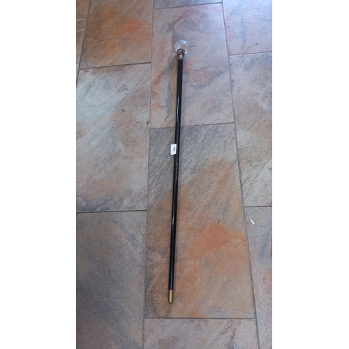 50 - Walking cane with faceted glass spherical knop, foliate-cast metal collar and plain metal ferrule, o... 