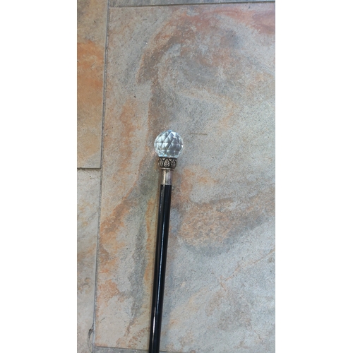 50 - Walking cane with faceted glass spherical knop, foliate-cast metal collar and plain metal ferrule, o... 