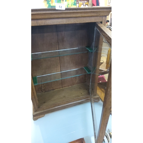 51 - Vintage glazed heavy oak counter top shop cabinet, the moulded cornice above a single hinged glass d... 