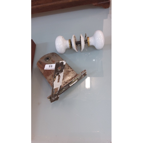 55 - Victorian-style white ceramic door knob set with brass collars and iron spindle, accompanied by a mo... 