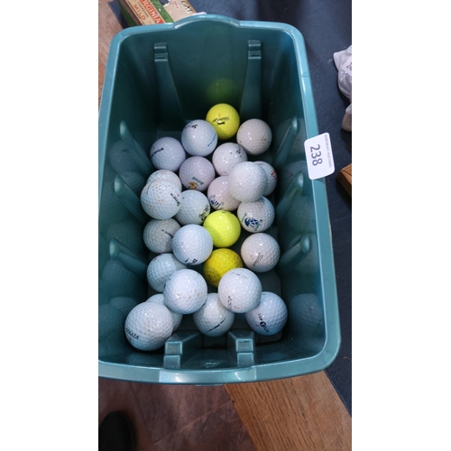 238 - A quantity of 25 assorted golf balls, including Srixon and Titleist examples, in white and yellow, w... 