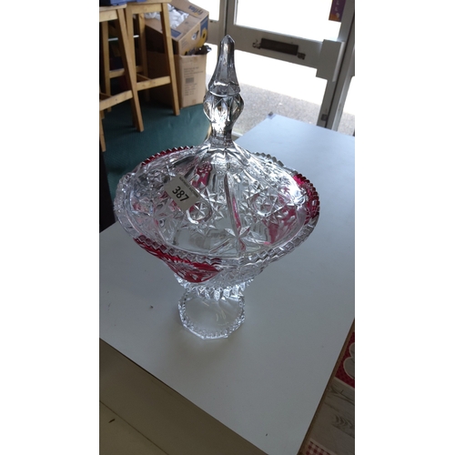 387 - Footed pressed-glass lidded bonbonnière, the domed cover with starburst and diamond-cut motifs and a... 