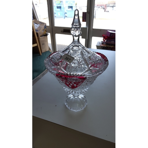 387 - Footed pressed-glass lidded bonbonnière, the domed cover with starburst and diamond-cut motifs and a... 