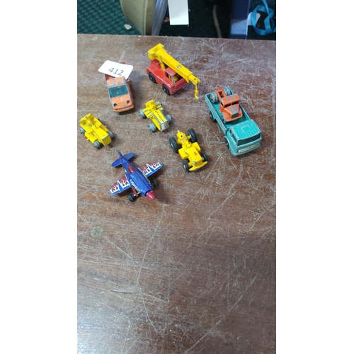 412 - A group of die-cast toy vehicles and models including a crane lorry, flatbed truck with load, saloon... 